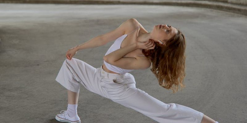 Person in a dynamic yet graceful stretching pose.